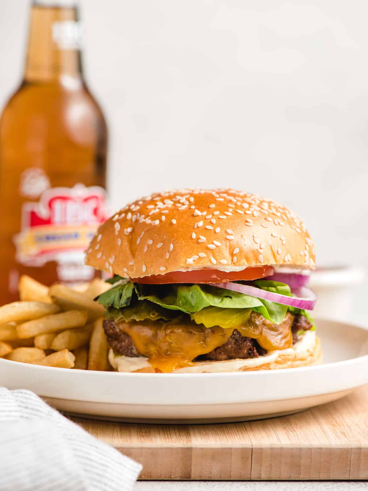 A classic burger and fries combo meal featuring an air fryer hamburger and a soda.