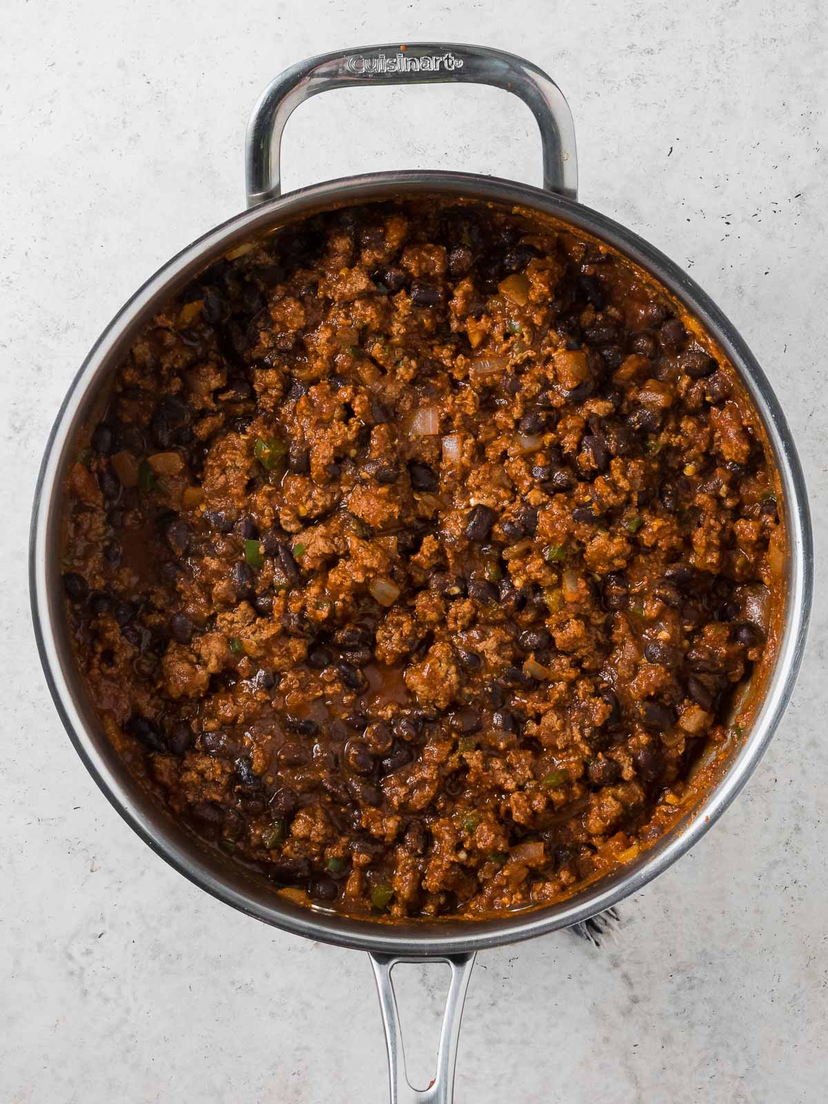 A skillet full of cooked and seasoned ground beef for Mexican Cornbread Casserole.