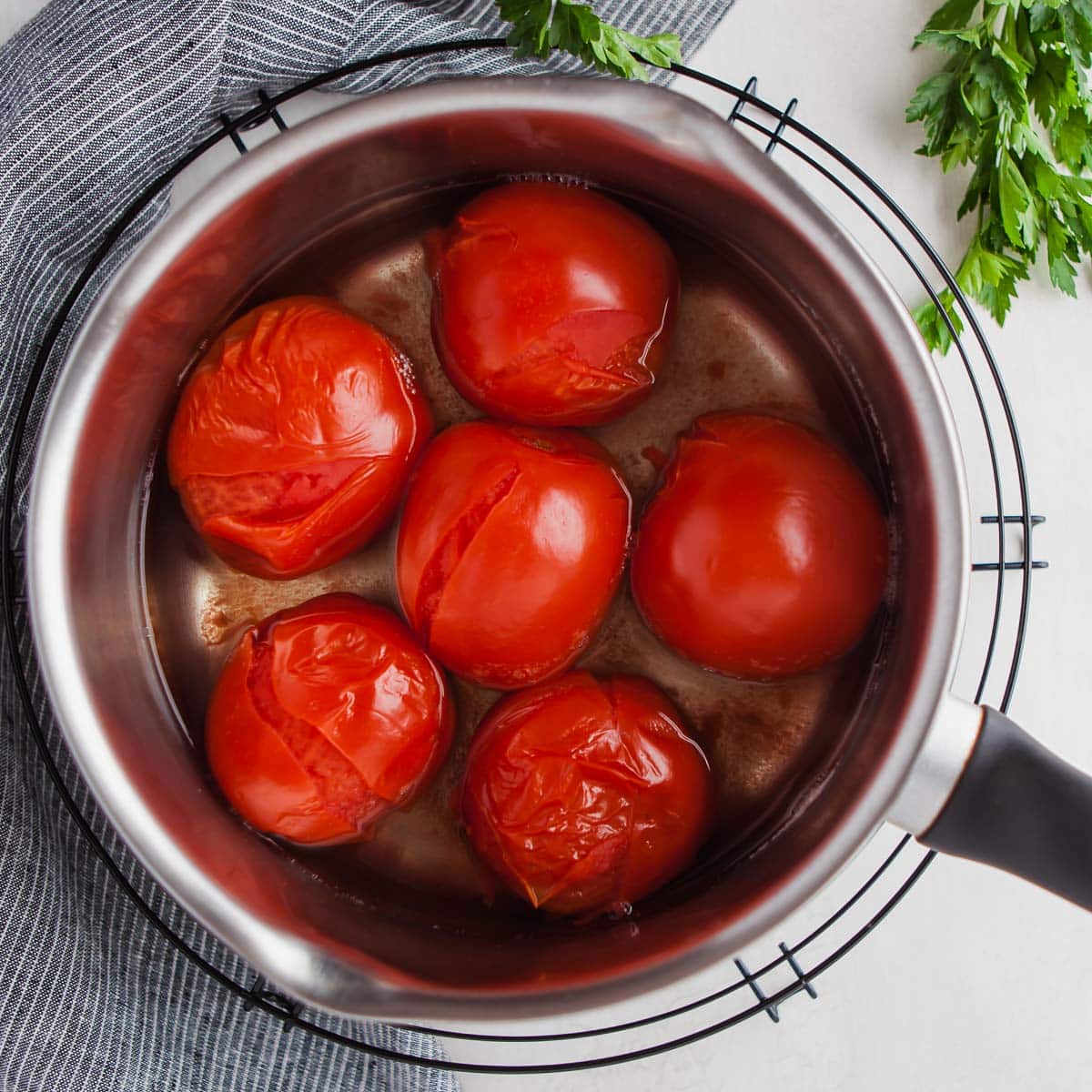 Boiled tomatoes for spicy meatballs in chipotle sauce.