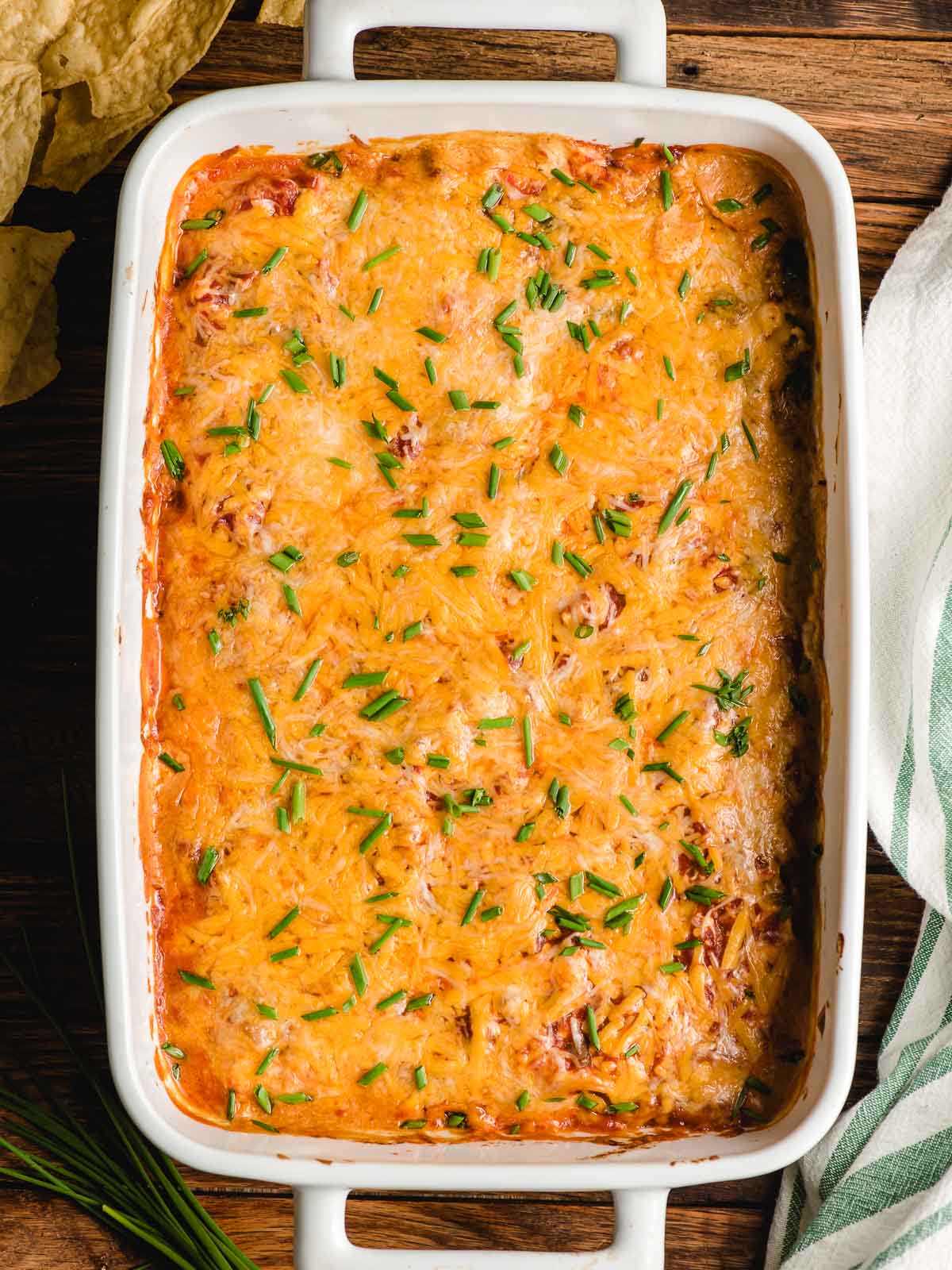 baked layered taco dip with meat ready for cold toppings