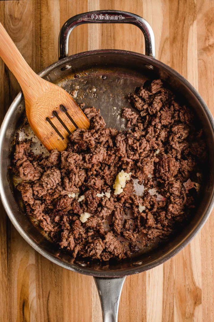 Ground beef browned in a skillet with minced garlic.