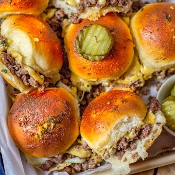 A tray full of Ground Beef Sliders with toasted golden tops.