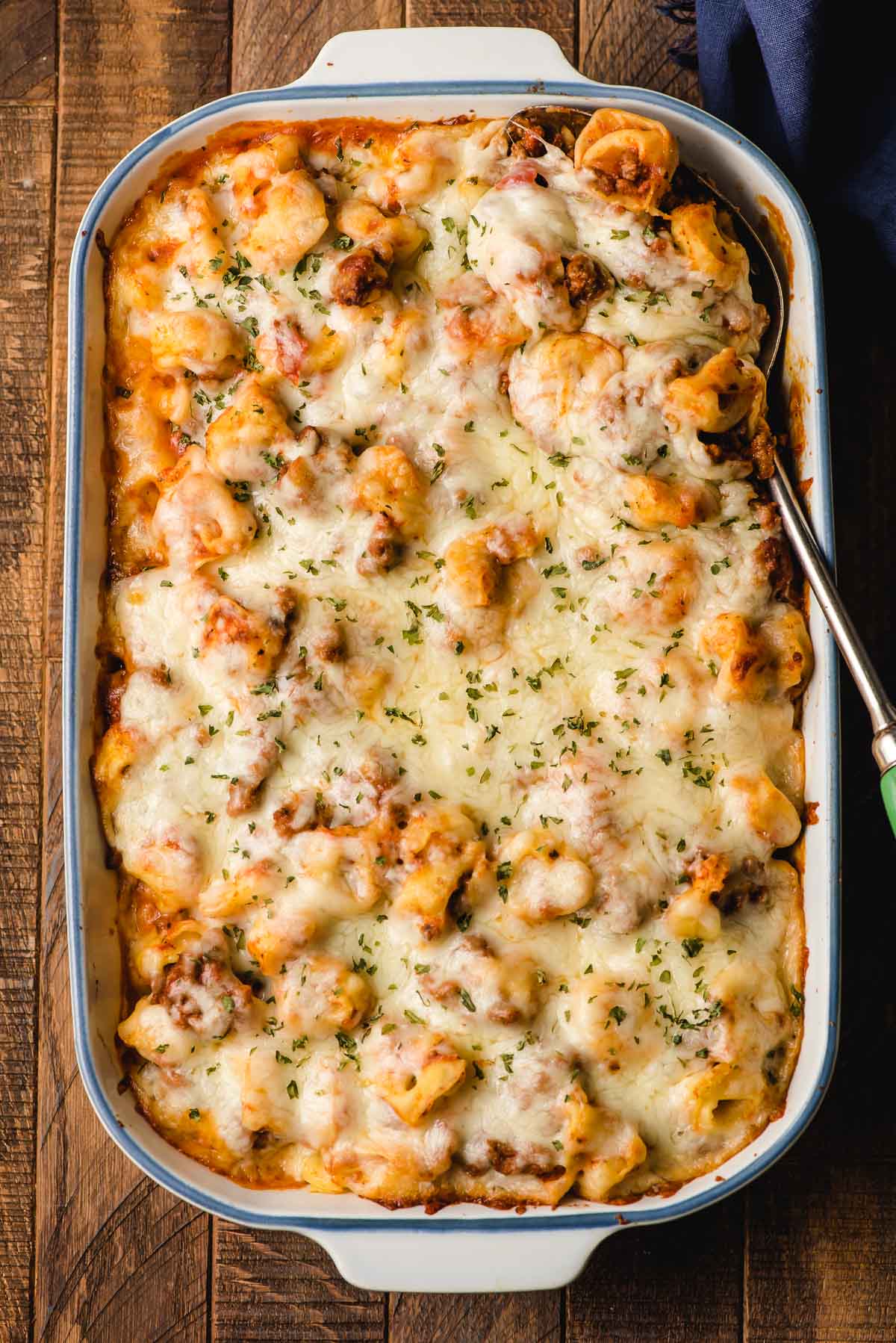 Baked tortellini casserole covered with mozzarella cheese.
