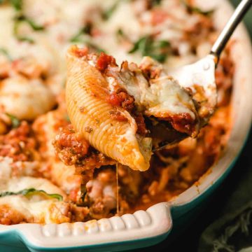 A scoop of cottage cheese stuffed shells with ground beef.