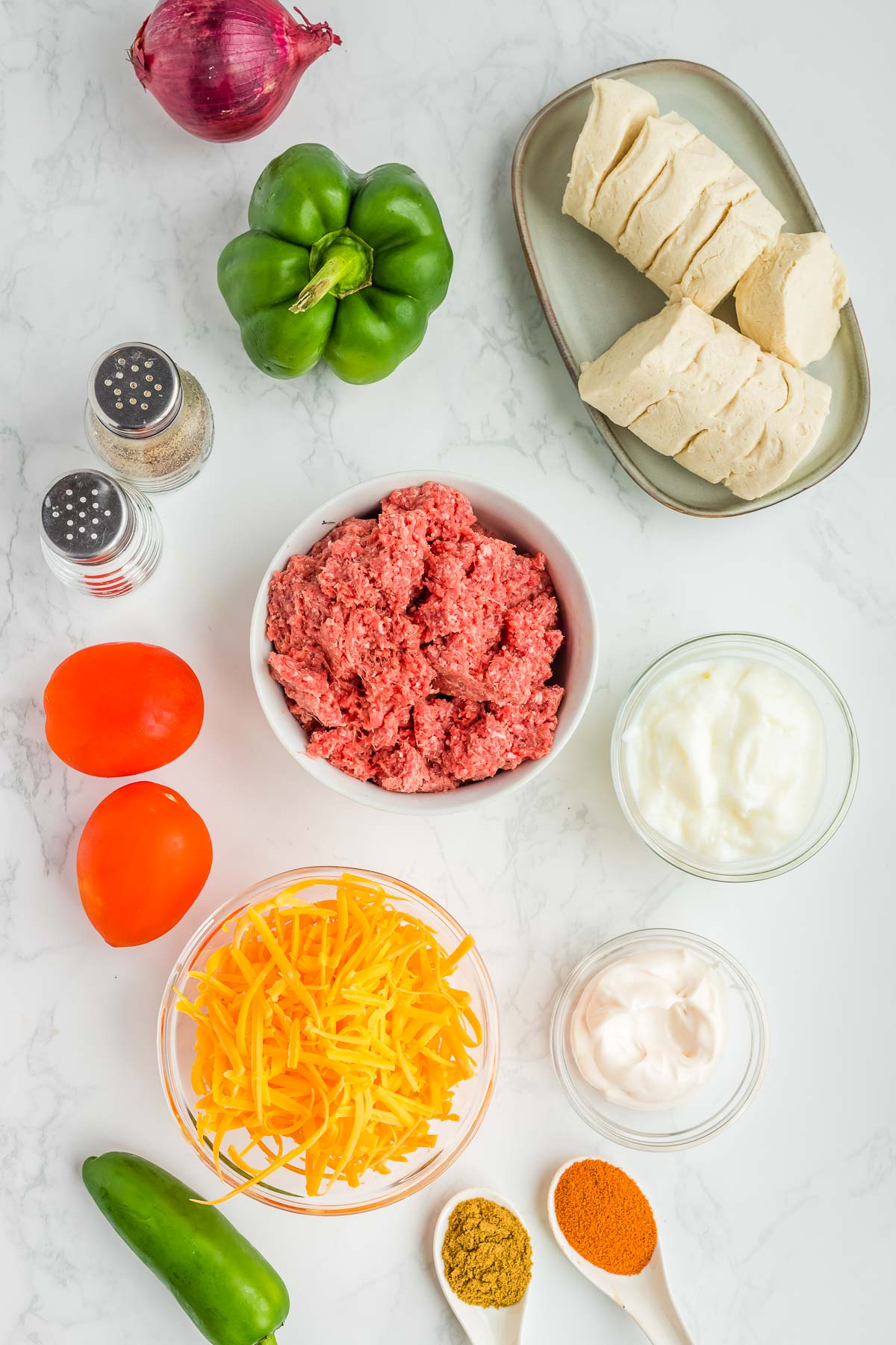 Ingredients for John Wayne Casserole in bowls on a white background.