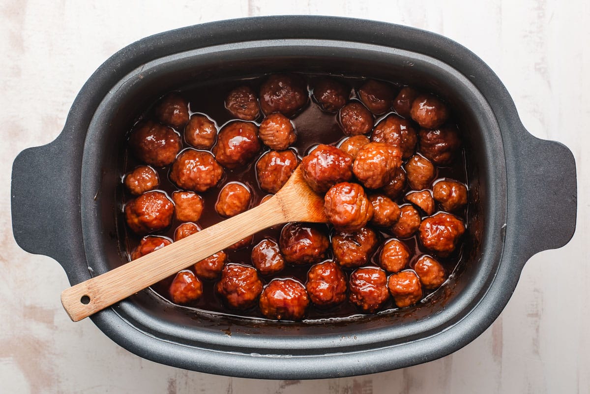 Meatballs with grape jelly and bbq sauce in a slow cooker.