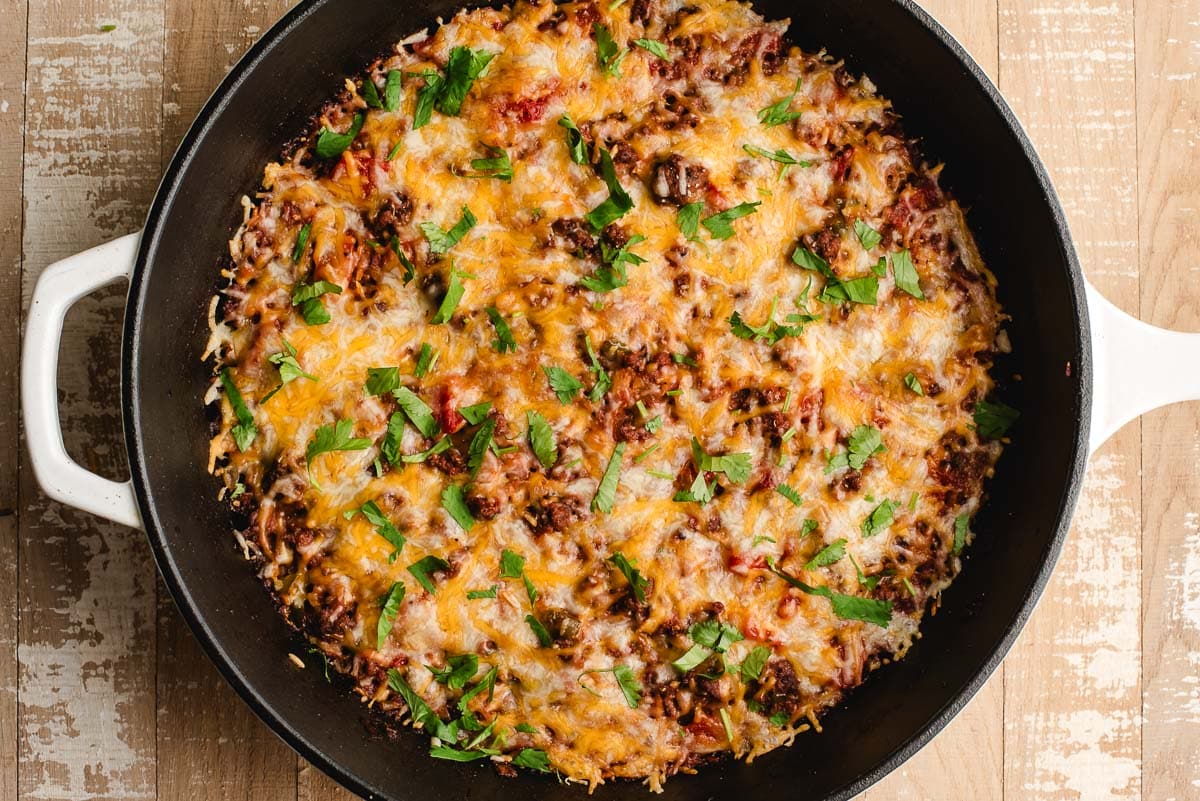 Freshly baked skillet Texas Hash with melted cheese on top.