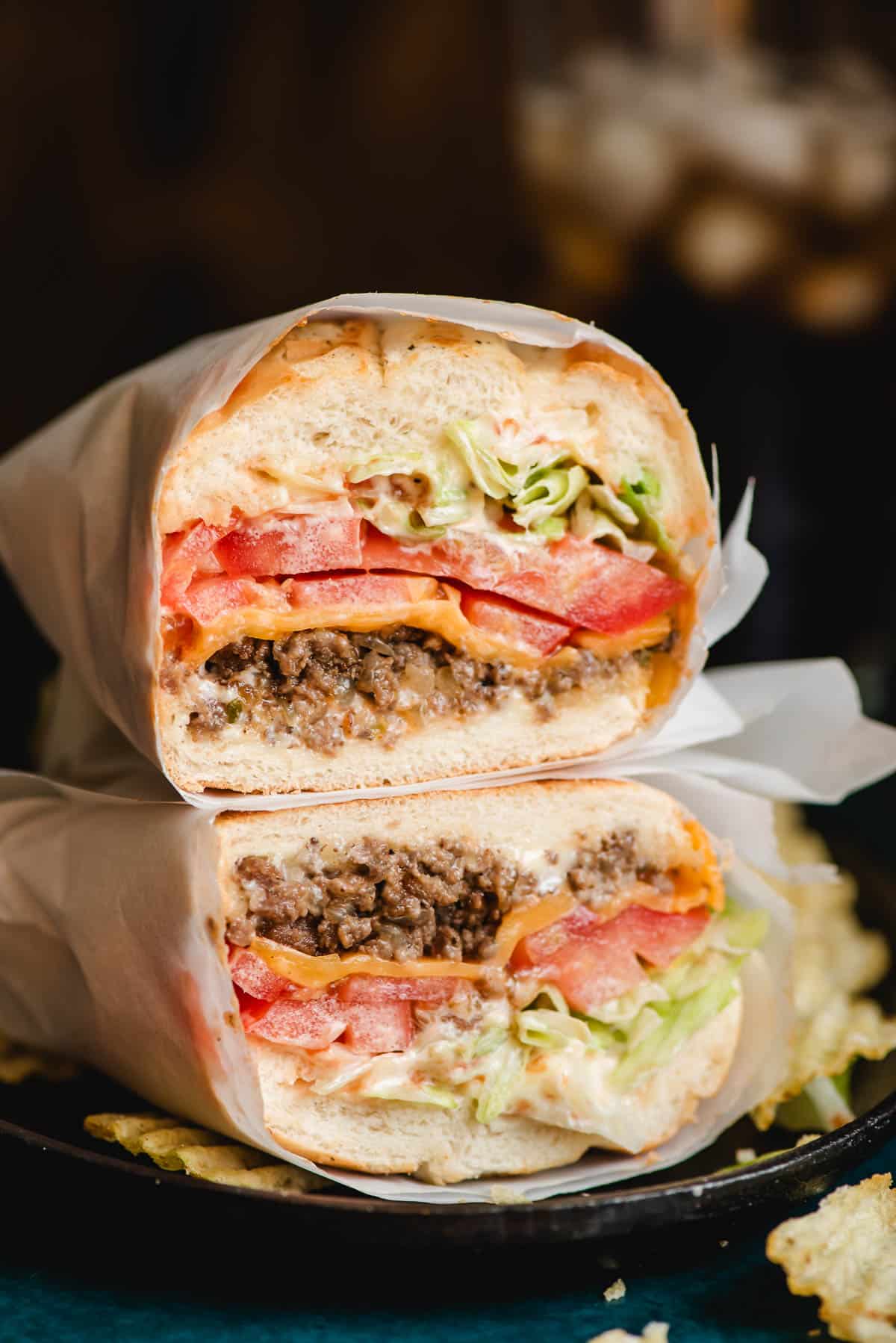 Halved Chopped Cheese Sandwich stacked on top of each other.