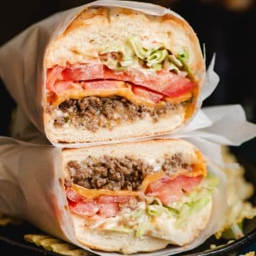 Halved Chopped Cheese Sandwich with ground beef, cheese, lettuce, and tomato.