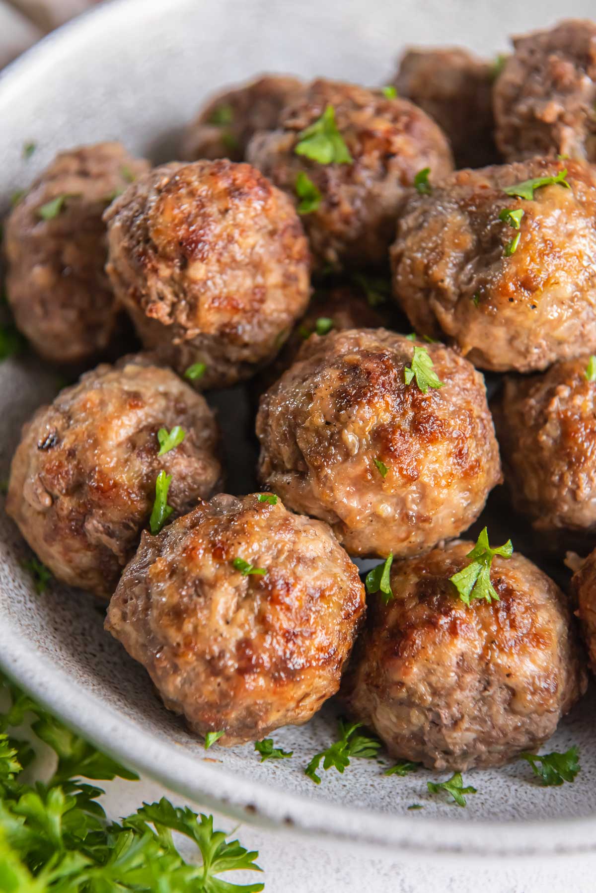 Air Fryer Meatballs dusted with parsley.
