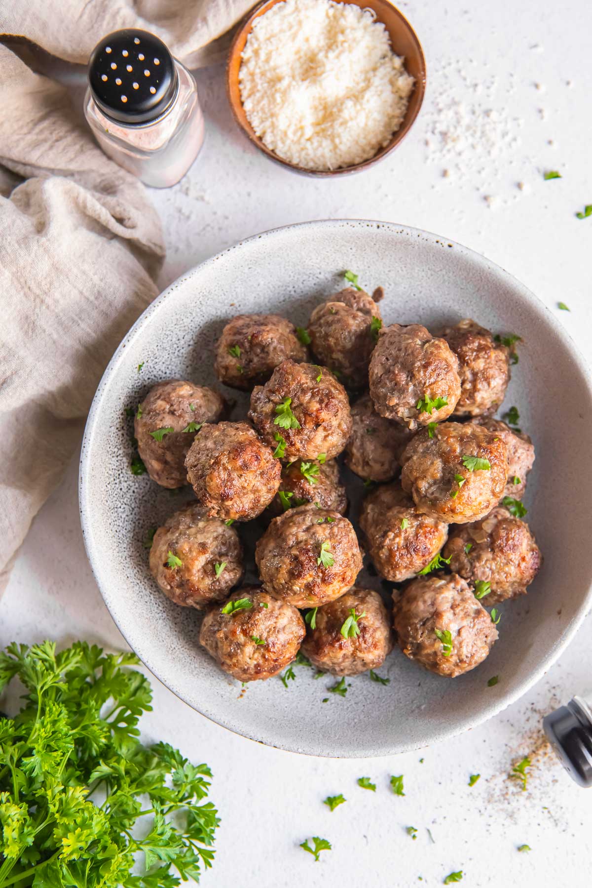 A bowl of Air Fryer Meatballs are served on a table.