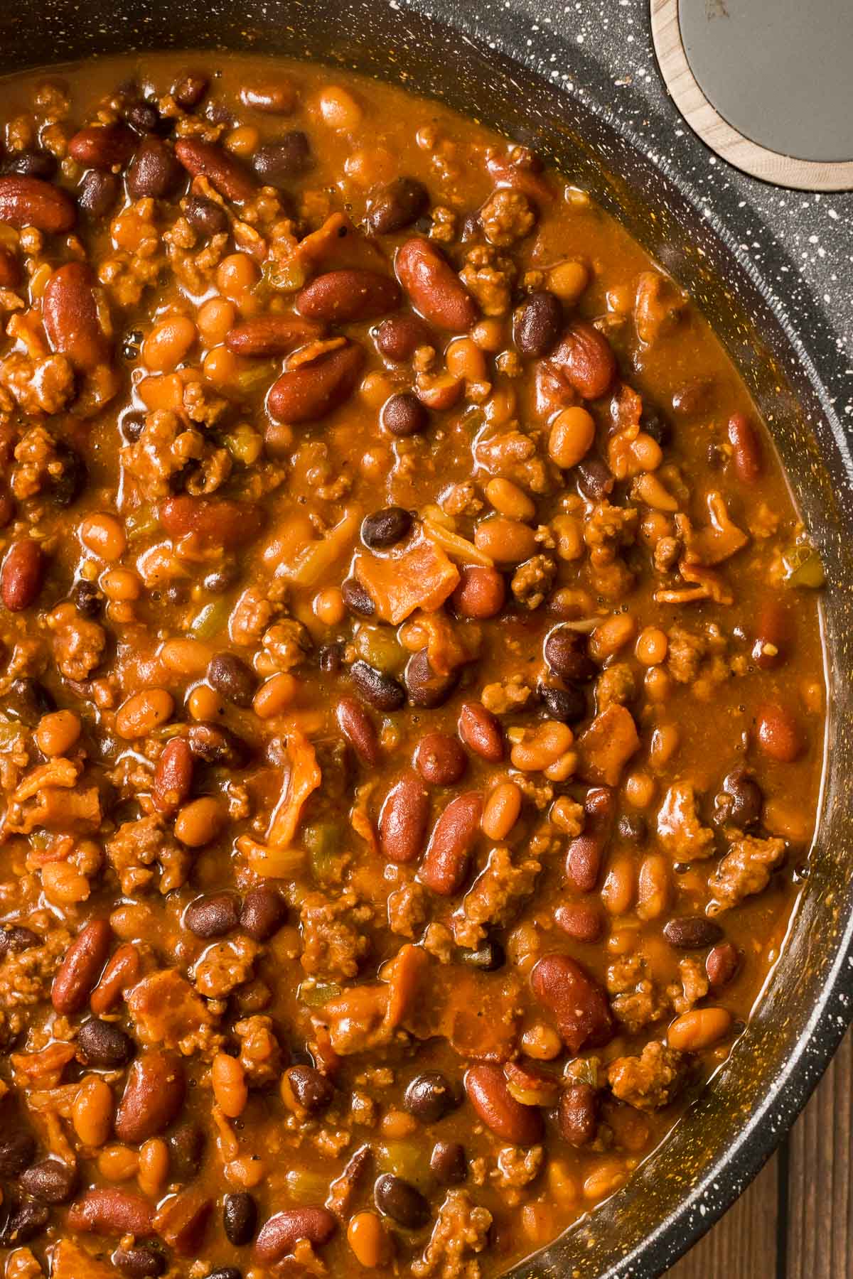 Cowboy baked beans with hamburger in a pot.