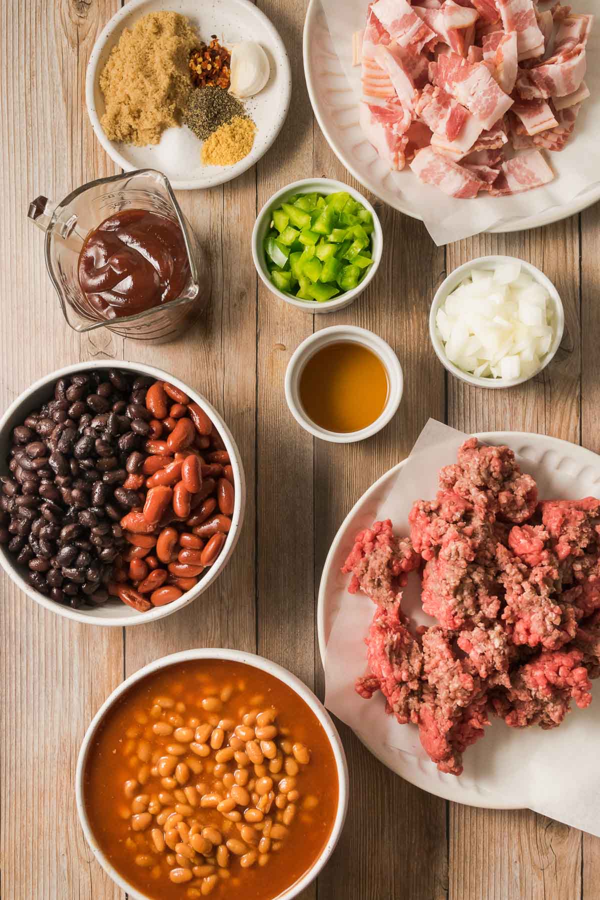 All of the ingredients for cowboy baked beans recipe in prep bowls.