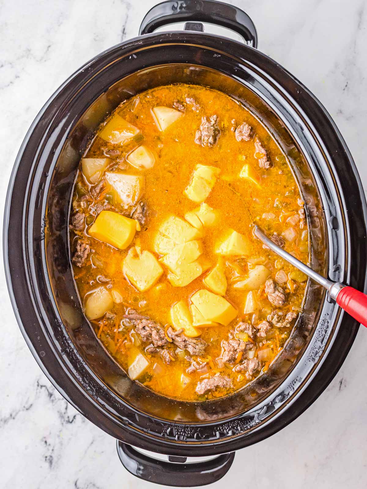 Crock Pot Cheeseburger Soup cooking in the slow cooker.