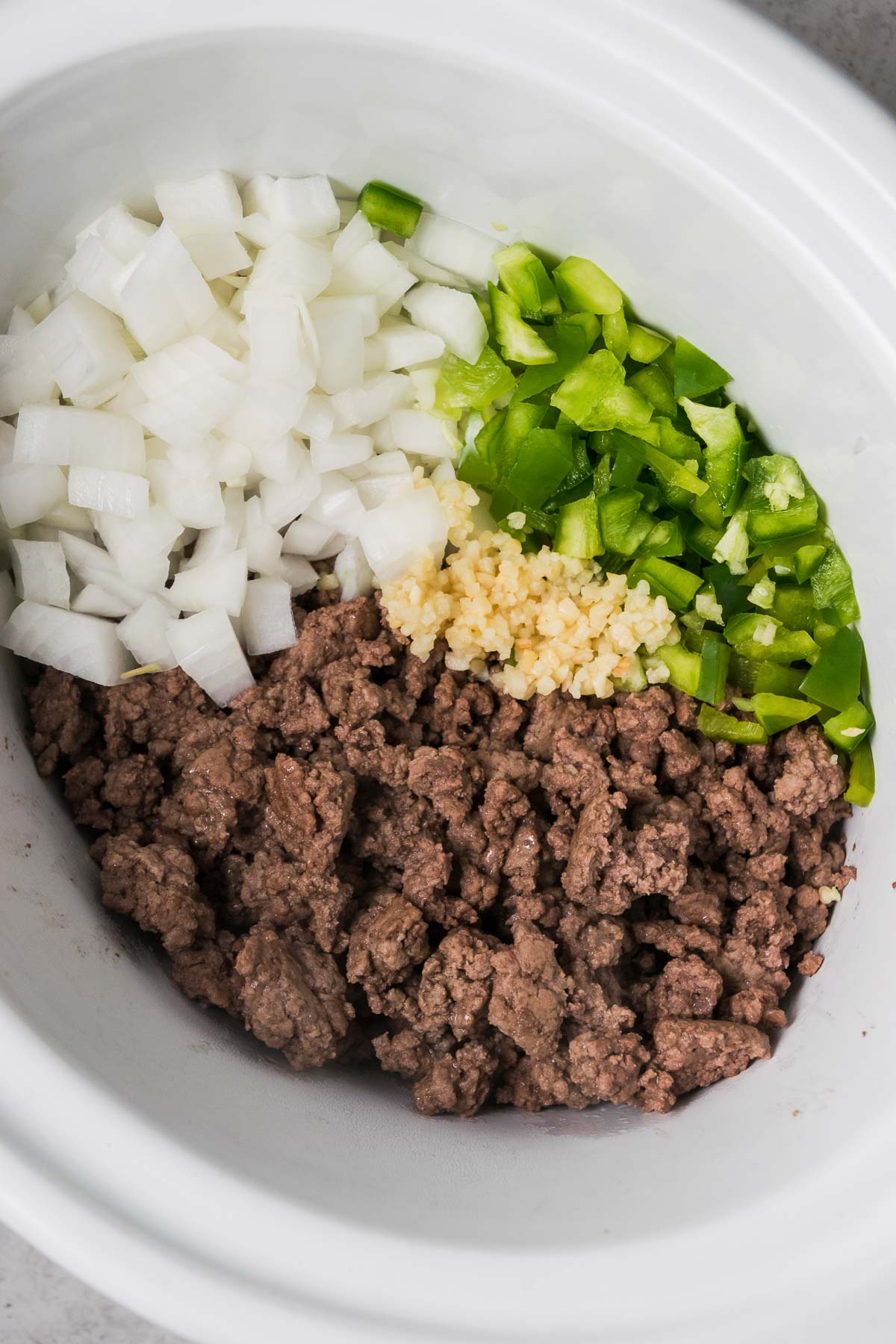 Ground beef and veggies in a crock pot.