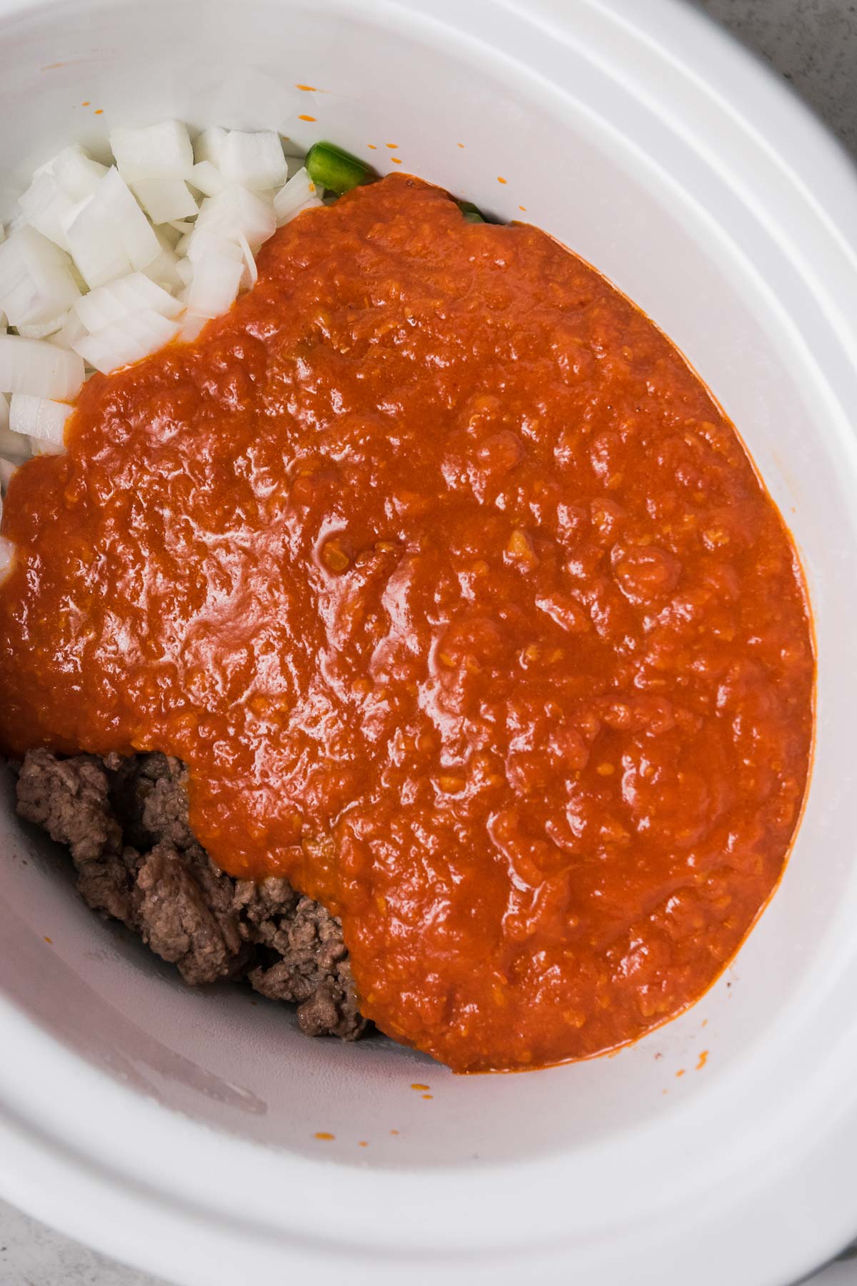 Tomato sauce covers slow cooker goulash ingredients.