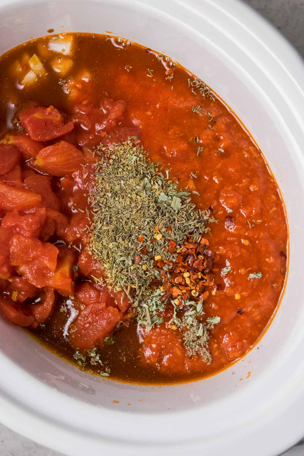 Diced tomatoes herbs and spices are added to the slow cooker goulash.