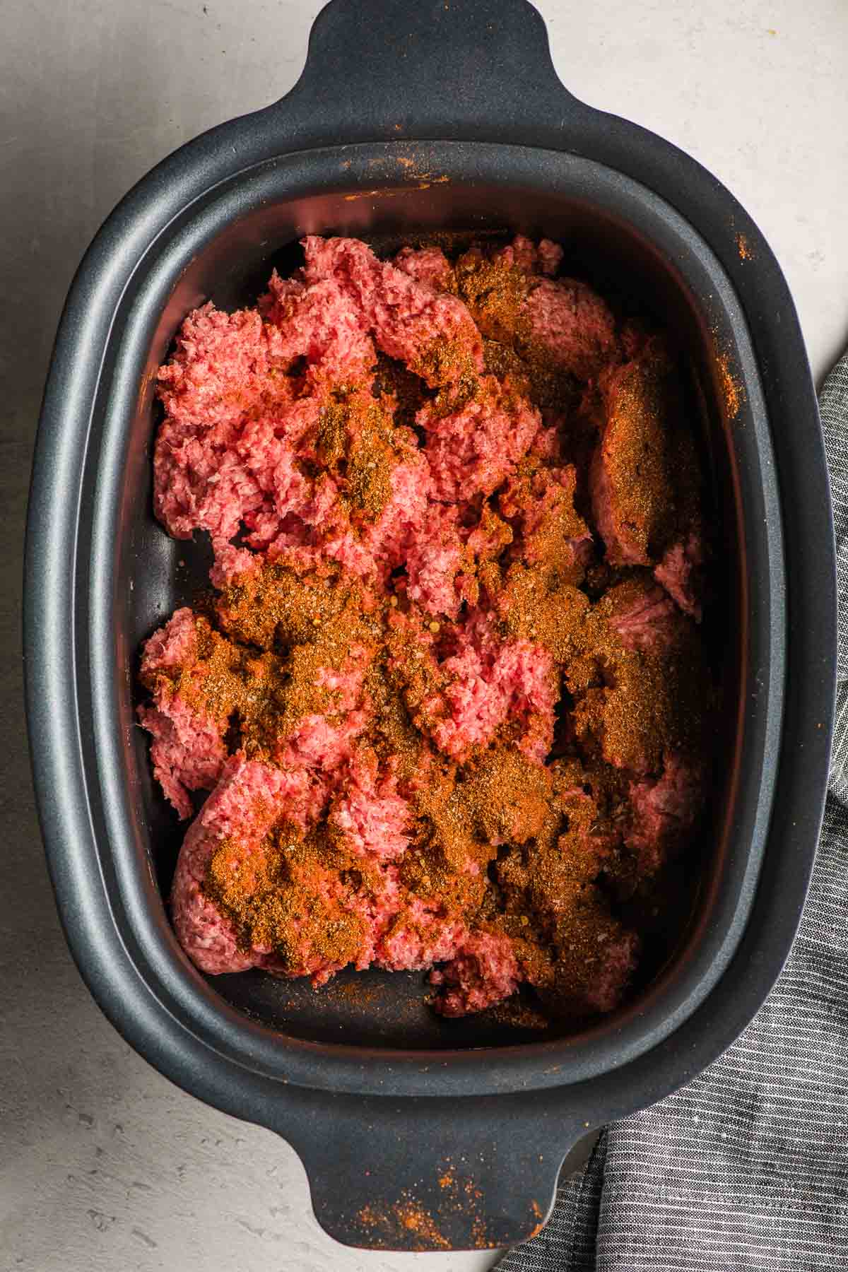 Seasoned ground beef in the crock pot.