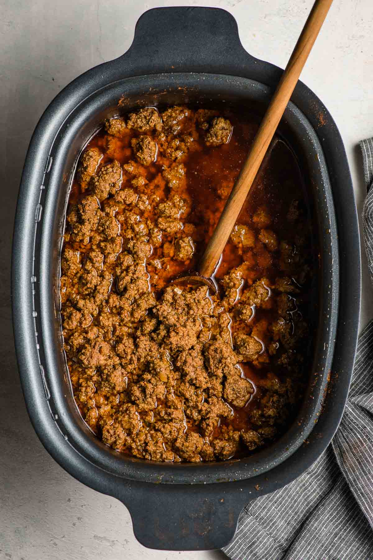 A crock pot full of slow cooker taco meat.