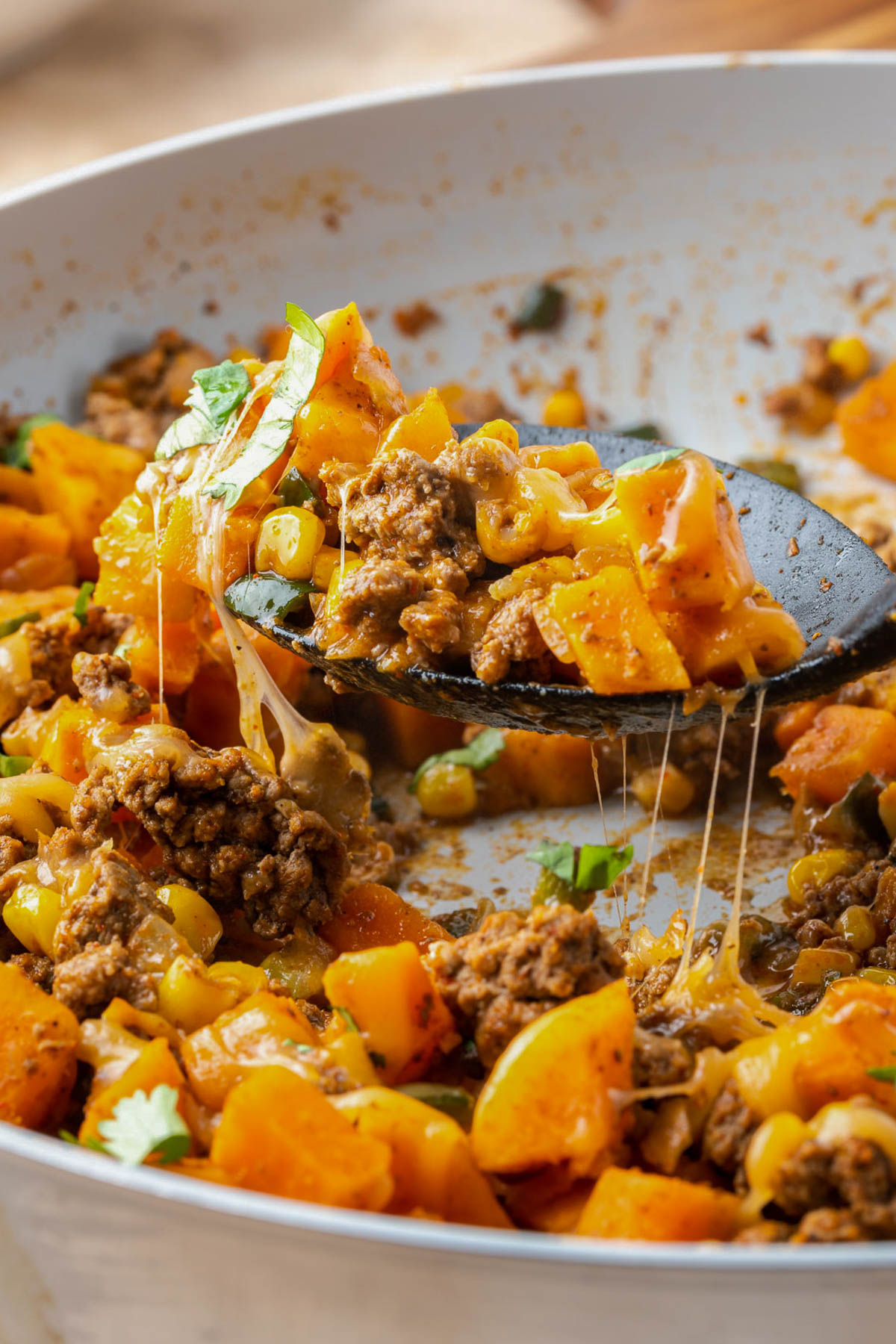 A cheesy scoop of Ground Beef and Sweet Potato Hash.