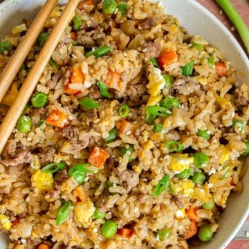 Ground Beef Fried Rice in a white bowl with chopsticks.