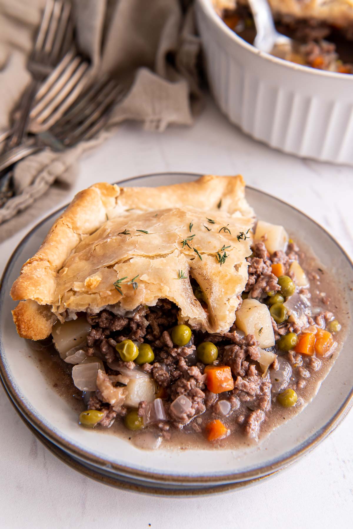Scoop of ground beef pot pie on a plate.