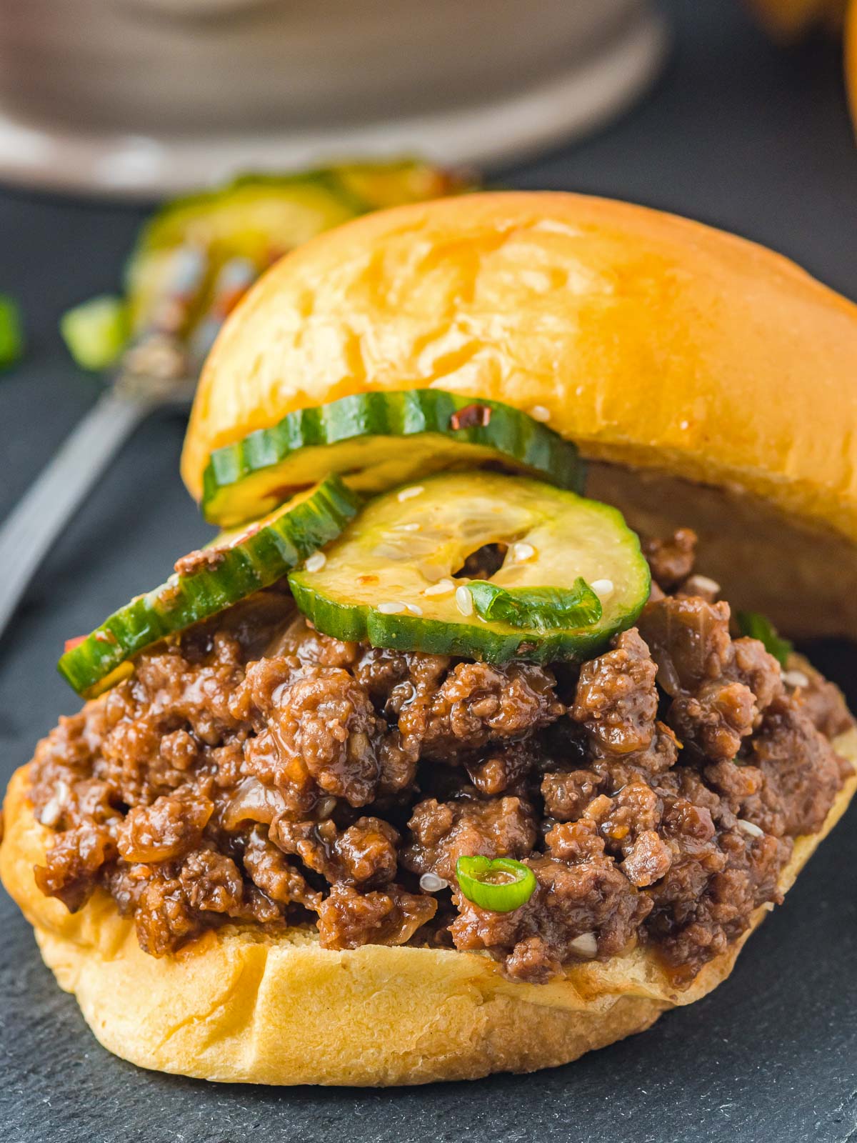 Open faced Korean Sloppy Joes with pickles on top.