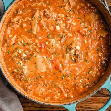 Lasagna soup in a teal Dutch oven.