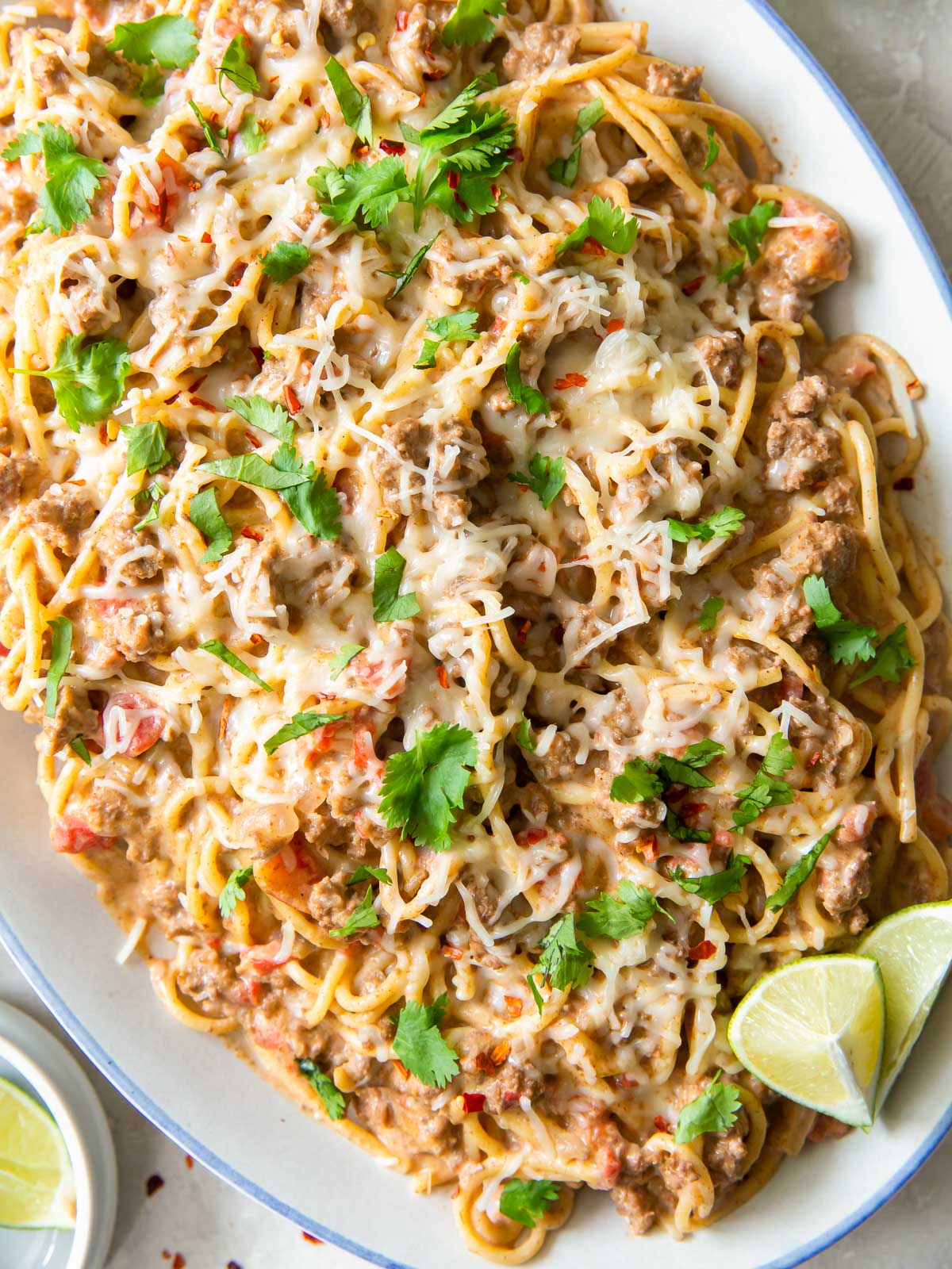 A serving platter piled high with creamy one pot taco spaghetti.