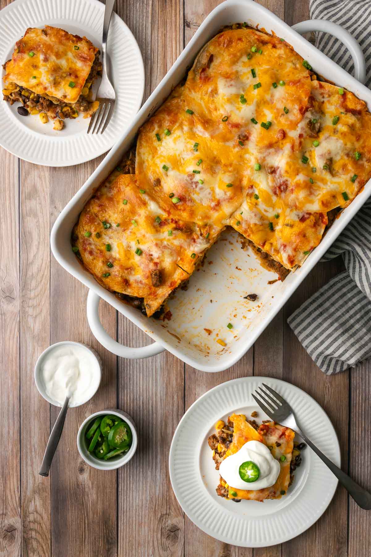 Tortilla Lasagna casserole shown with a slice taken out and plated.